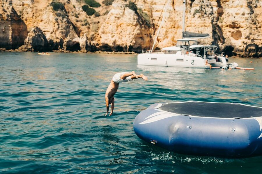 From Lagos: 2.5-Hour Guided Coastal Boat Tour & Grotto Visit - Swimming and the aqua trampoline