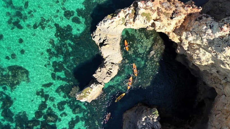 From Lagos: Ponta da Piedade Caves Kayak Tour from Catamaran - Sliding into the kayak at Ponta da Piedade