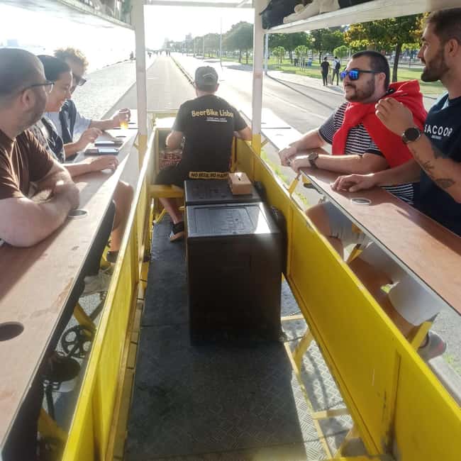 Lisbon: 1-Hour Beer or Sangria Bike Sightseeing Tour - Passing beneath the 25 de Abril Bridge