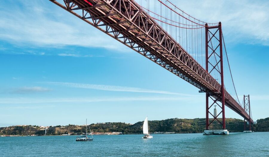 Lisbon: City Skyline Sailboat Cruise with Drink and Snacks - Under the 25 de Abril Bridge