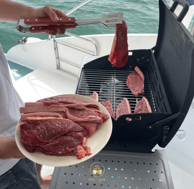 Lisbon: Private Luxury Catamaran Tour with Welcome Drink - Under the 25th of April Bridge toward central Lisbon