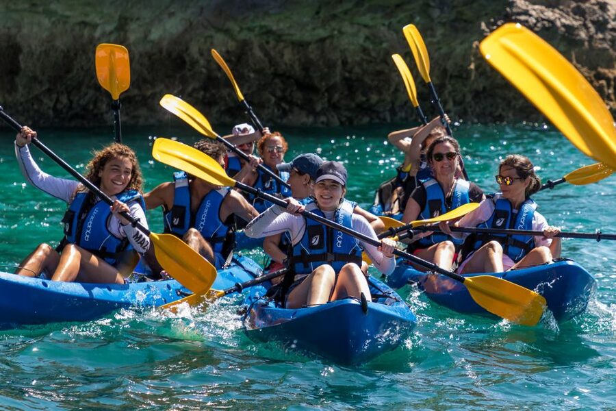 Sesimbra: Arrabida Natural Park & Caves Guided Kayaking Tour - Meeting the guide beside Sesimbra’s blue kayaks